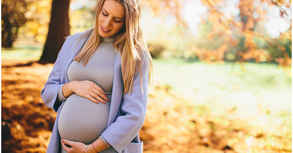Pregnant woman looking calm and in a park