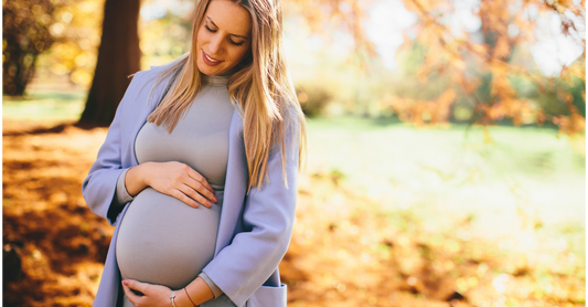 Pregnant woman looking calm and in a park