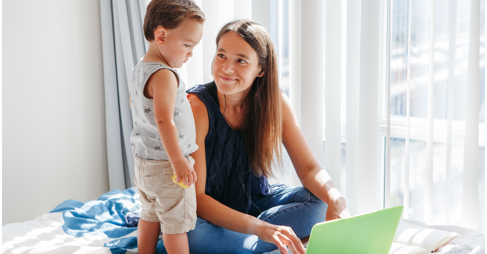 Mom with child who is looking at the computer