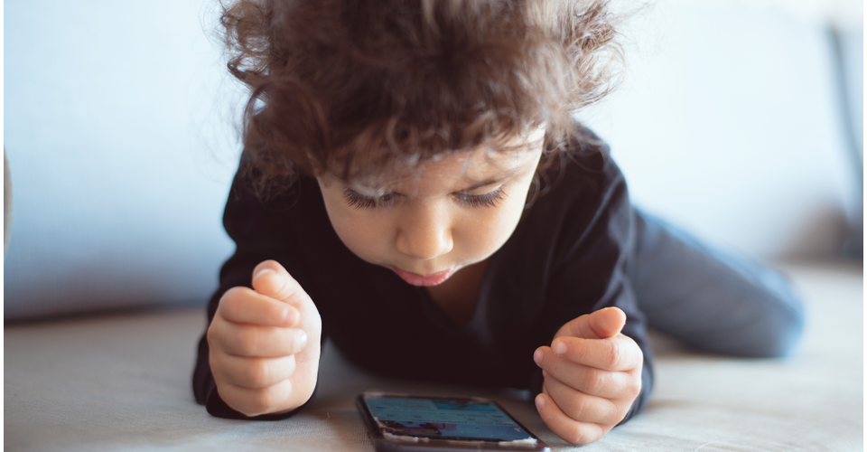 Toddler watching an educational program on phone