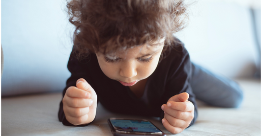Toddler watching an educational program on phone