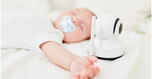 aby monitor on a nursery shelf showing live video feed of sleeping baby.