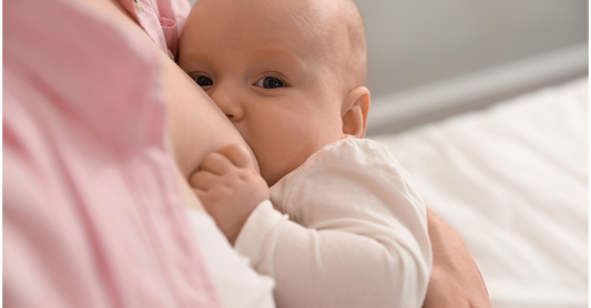 Breastfeeding mother holding newborn, symbolising safe and mindful nursing.