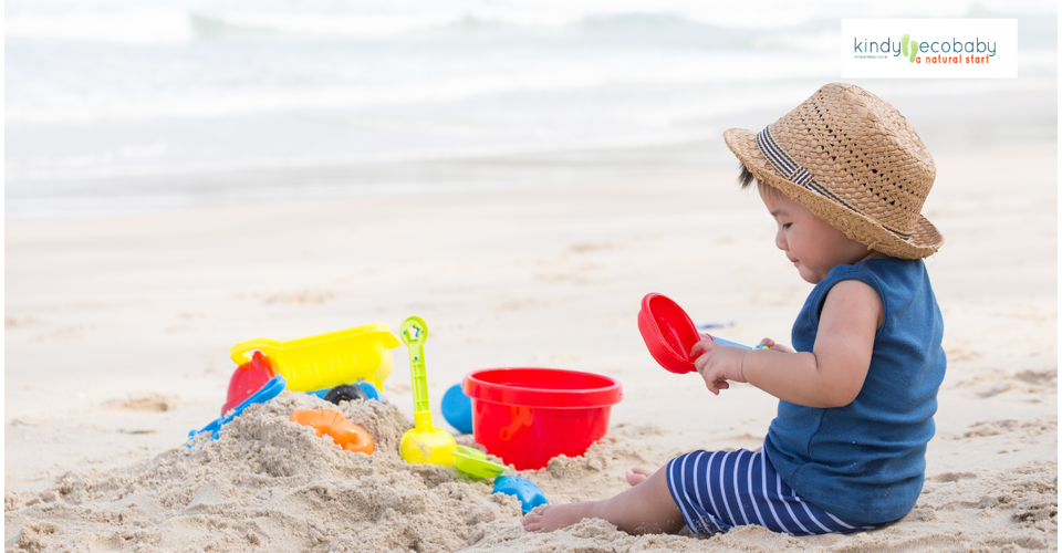 Child playing outdoors in tropical Australia wearing sunhat and protective clothing.
