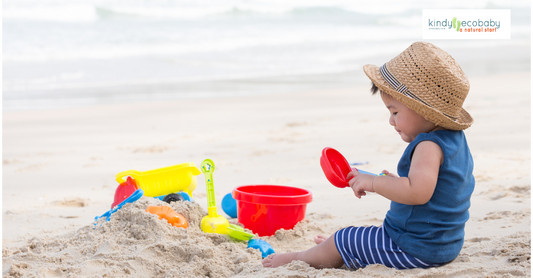 Child playing outdoors in tropical Australia wearing sunhat and protective clothing.