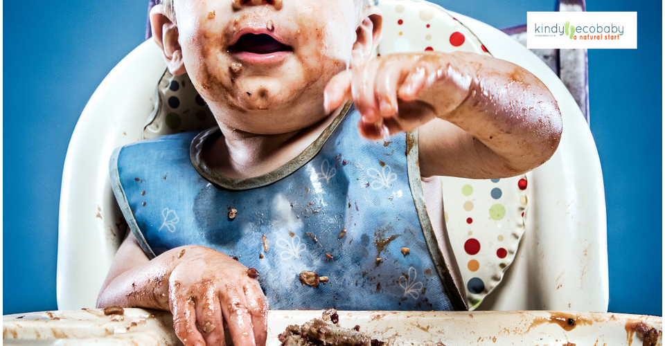 Baby in high chair covered in food