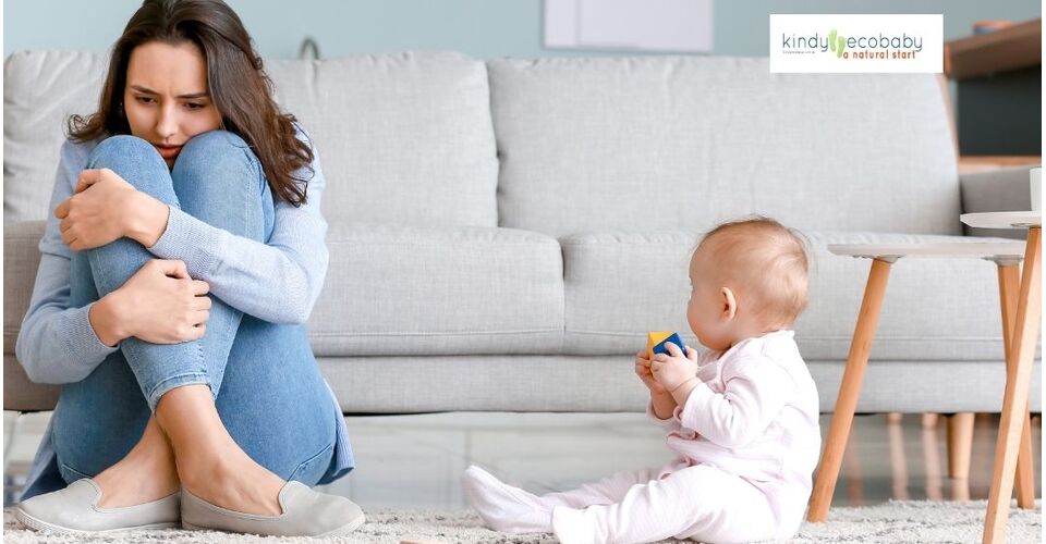 Mother holding her baby while looking out the window, symbolizing hope during postnatal depression.